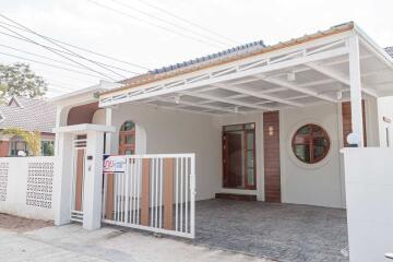 Front view of a modern single-story house with a carport