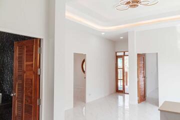 Spacious and modern main living area with wooden doors and bright lighting