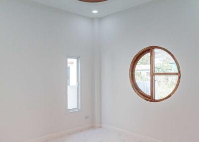 Bright empty room with circular and rectangular windows