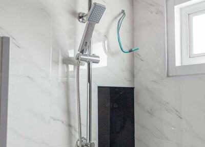 Modern shower with a rain showerhead and handheld spray