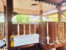 Wooden porch with ceiling decor and safety fire extinguisher