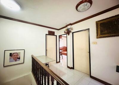 Hallway with wall art and chandelier