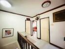 Hallway with wall art and chandelier