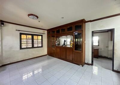 Main living area with wooden cabinetry and tiled floor