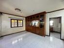 Main living area with wooden cabinetry and tiled floor