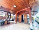 Covered patio area with wooden ceiling and pillars