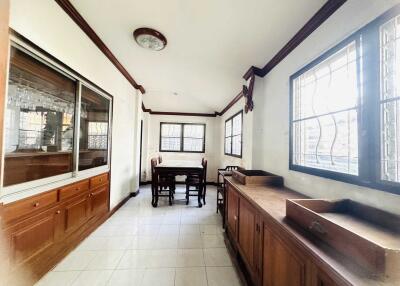 Spacious dining area with large windows and wooden cabinets