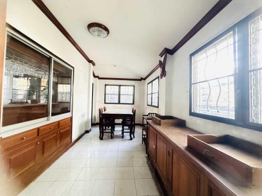 Spacious dining area with large windows and wooden cabinets