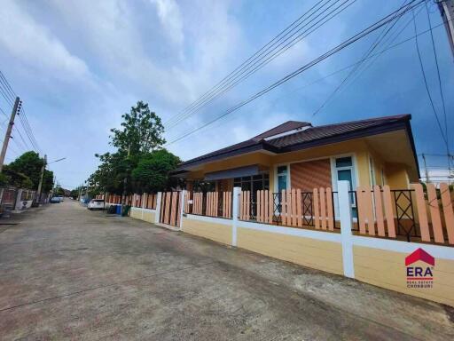 Exterior view of a residential building with a fenced yard