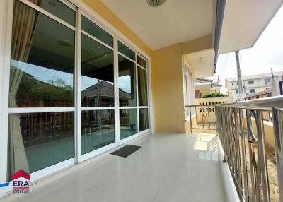 Spacious balcony with glass doors and metal railing