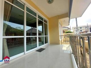 Spacious balcony with glass doors and metal railing