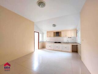 Spacious kitchen with built-in cabinets and large windows