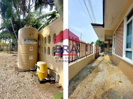 Exterior view of property with water storage tank and gravel walkway