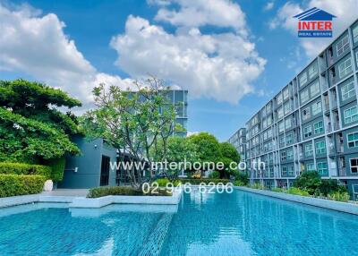 Outdoor pool area with surrounding modern apartment buildings