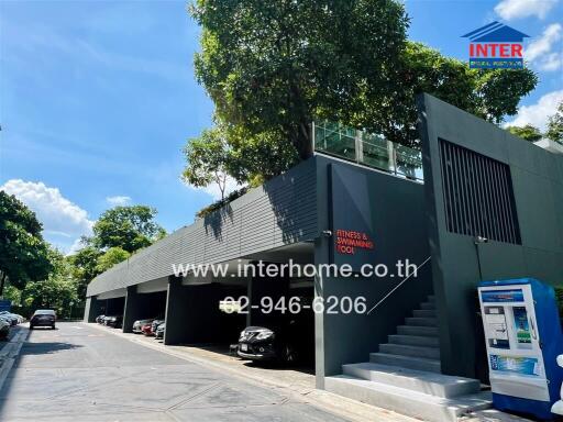 Residential building with parking area and fitness swimming pool sign