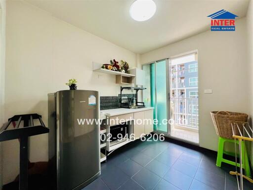 Bright kitchen with modern appliances and access to balcony