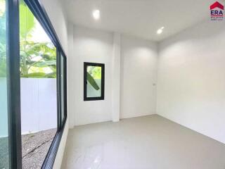 Bright and empty bedroom with large windows