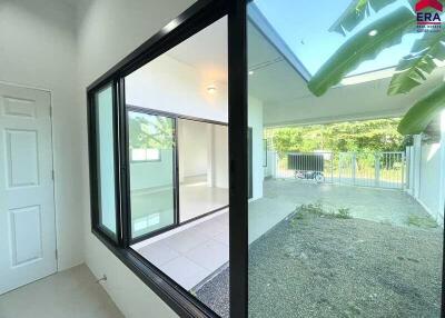 View of a house with a courtyard and a large window