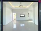 Empty living space with white walls and tiled floor
