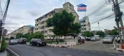 Exterior view of residential buildings and street with parked cars