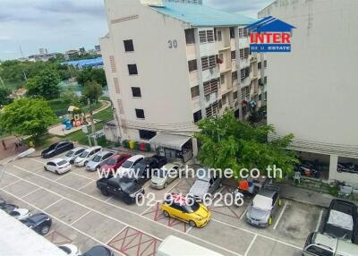 View of apartment building with parking area