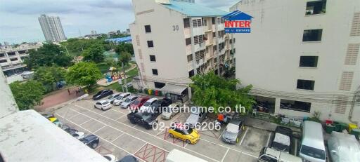 View of apartment building with parking area