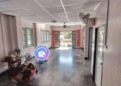 Spacious main living area with large windows and stone flooring