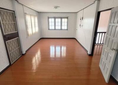 Empty room with wooden floor and windows