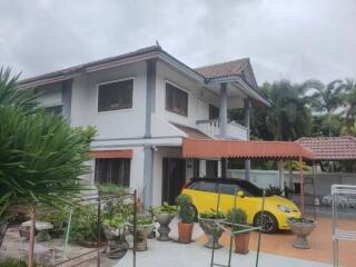 Two-story house with a yellow car parked outside