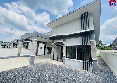 Modern single-story house with large windows and a carport