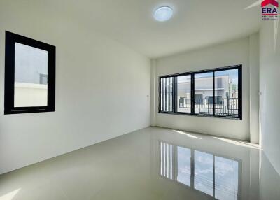 Modern living room with large windows and tiled floor