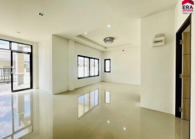 Bright and spacious living room with large windows and modern chandelier