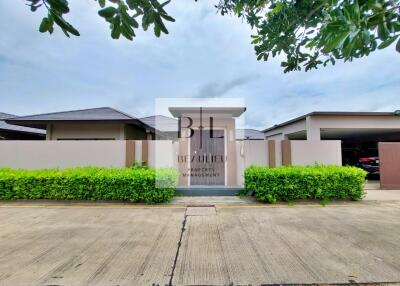 Front view of a modern residential building with lush greenery