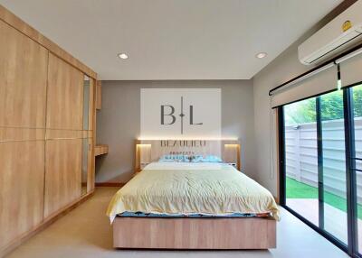 Modern bedroom with built-in wardrobe and large sliding glass door