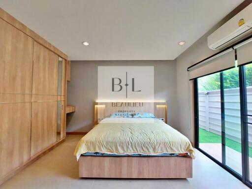 Modern bedroom with built-in wardrobe and large sliding glass door