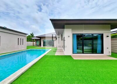 Modern house with swimming pool and lawn