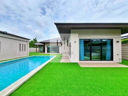 Modern house with swimming pool and lawn