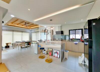Modern kitchen and dining area with bar stools and natural lighting