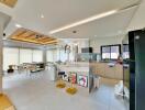 Modern kitchen and dining area with bar stools and natural lighting