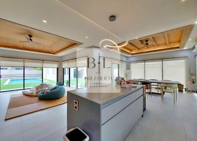 Spacious open-concept living area with modern furnishings and ample natural light