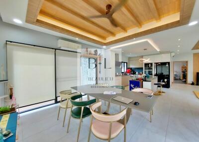 Modern kitchen with dining table and chairs, wooden ceiling, and open layout