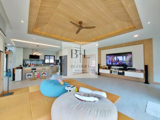 Modern living room with open kitchen and wooden ceiling