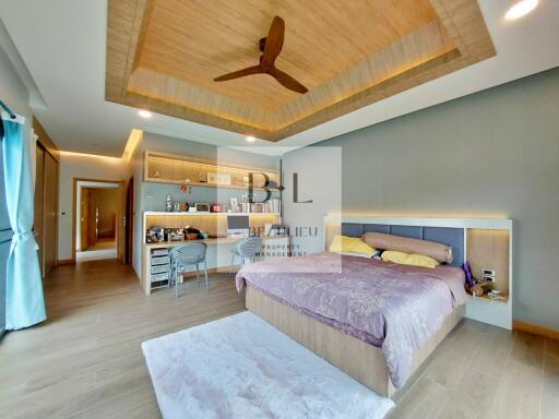 Spacious, modern bedroom with built-in storage and ceiling fan