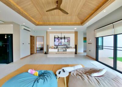 Spacious and modern living room with wooden ceiling and comfortable seating