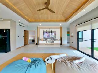 Spacious and modern living room with wooden ceiling and comfortable seating