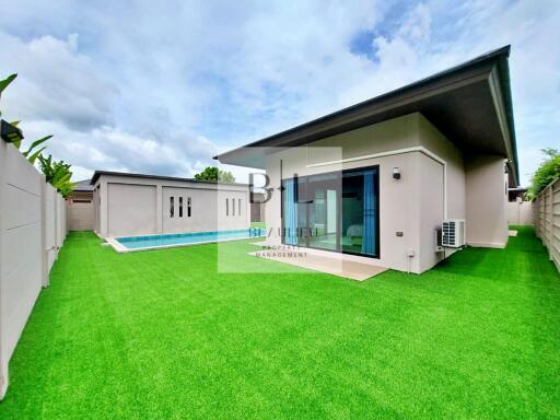 Modern house with swimming pool and green lawn