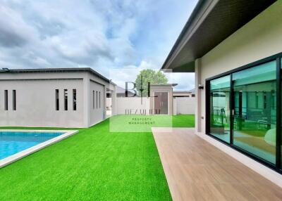 Outdoor area with pool and artificial grass