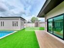Outdoor area with pool and artificial grass