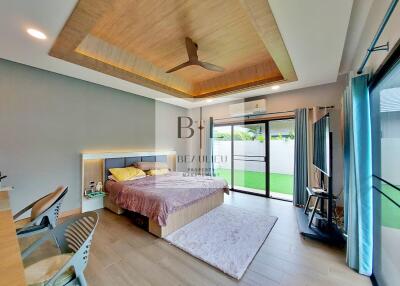 Spacious bedroom with modern decor and garden access