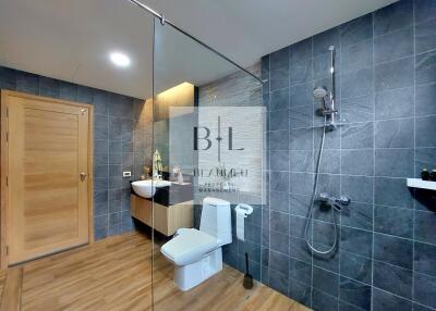 Modern bathroom with walk-in shower and wooden flooring